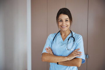 Charming female doctor with stethoscope standing in clinic