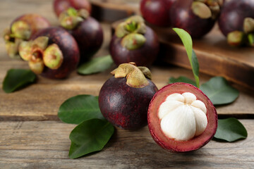 Delicious tropical mangosteen fruits on wooden table