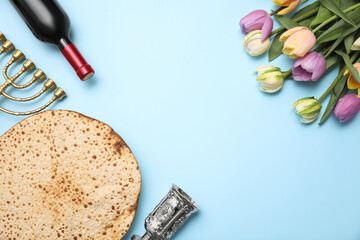 Flat lay composition with matzo on light blue background, space for text. Passover (Pesach)...