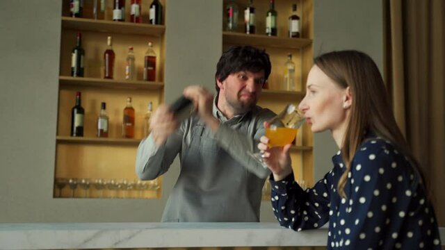 Crazy bartender shakes a shaker at the bar
