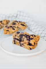 Homemade oatmeal scones with berries on white plate. Vegan sweet baked food. Gluten free pastry.