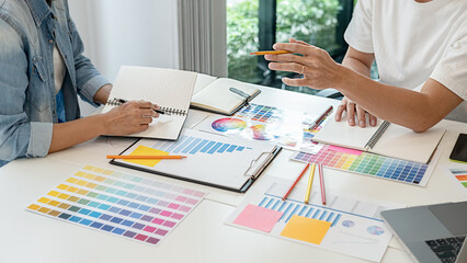 Graphic design and color swatches and pens on a desk. Architectural drawing with work tools and accessories.