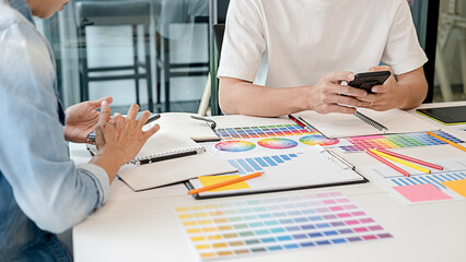 Graphic design and color swatches and pens on a desk. Architectural drawing with work tools and accessories.