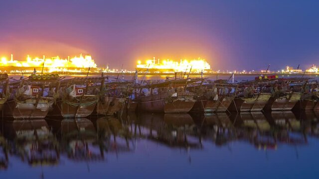 Fishing boat parked near the fish market next to Kuwait City Area day to night timelapse