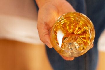 Woman's hand holding a glass of cognac, alcohol concept