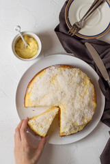 Sponge cake with cream on top and coconut flour. White background