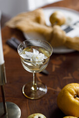 A delicate composition with yellow flowers and fruits, with wedding invitations. Wedding decor in trendy shades, composition on the table with printing.