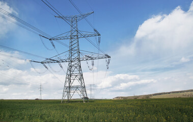 High voltage electric tower background of blue sky with clouds