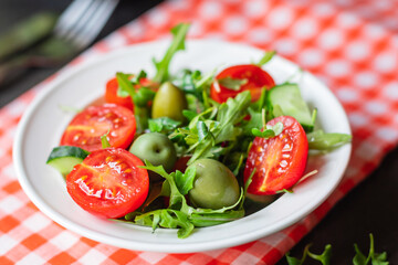 salad vegetable olives tomato cucumber, lettuce mix leaves snack meal diet vegan or vegetarian food copy space food background rustic. top view 