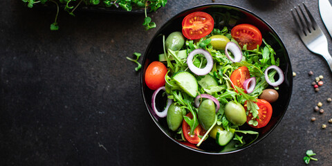 salad vegetable olives tomato cucumber, lettuce mix leaves snack meal diet vegan or vegetarian food copy space food background rustic. top view 