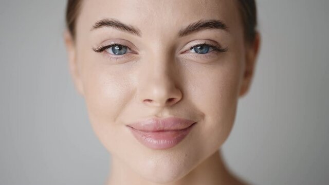 Woman face close up beauty eyes lips skin beautiful young female model face looking camera