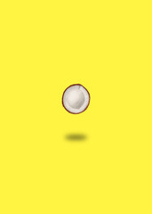 One ripe coconut on yellow background. Flat lay, top view. Summer concept.
