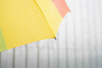 Close up of colorful umbrella part with raindrops