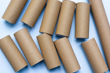 Empty toilet rolls on light blue background