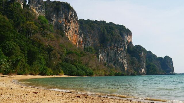 Tropical Sandy Beach Railay or Rai Leh West with Limestone Cliffs in the Background, Krabi Province, Thailand. Abstract summer holidays background video sunny tropical paradise beach with white sand.