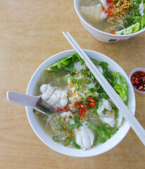Delicious street food meal / Seafood Soup Noodle / Fresh and chunky portion of succulent grouper fish meat cooked with Chinese rice wine in fish bone broth