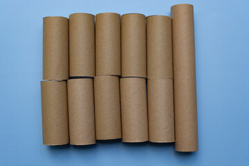 Empty toilet rolls on light blue background