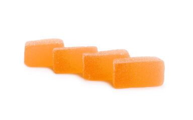 Tasty orange jelly candies on white background
