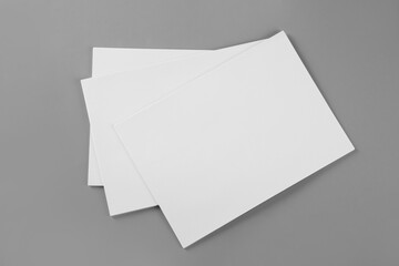 Blank brochures on grey background, top view. Mockup for design