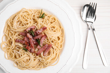 Delicious Carbonara pasta served on white wooden table, flat lay