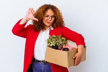 Young curvy woman moving to a new home isolated on white background showing a dislike gesture,...