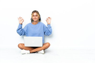 Young blonde Uruguayan girl with the laptop isolated on white background in zen pose