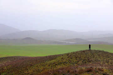 Fototapeta premium The photographer takes pictures of the beautiful landscape of the mountains. Gobustan. Azerbaijan.