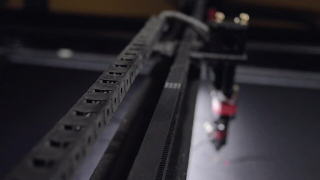 Industrial laser is cutting a pattern on a plastic. No people. High quality FullHD footage