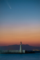 Comet neowise passing over the lighthouse in Kokkari village of Samos