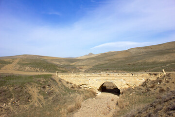 The old bridge over the river in the steppe.