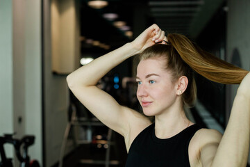 Fototapeta premium Young attractive girl in sportswear in a fitness club. Sports concept.
