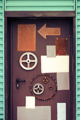 Vintage metal door decorated with arrows and gears