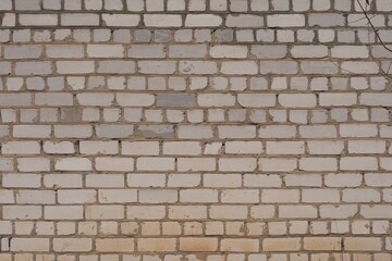 Fototapeta premium A white old brick wall, yellowed with age. Grunge texture. Brick background.