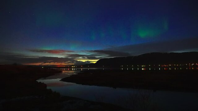 Stunning View Of Northern Lights In Colorful Night Sky Above River In Iceland. wide shot