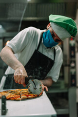 Chef cutting the pizza.