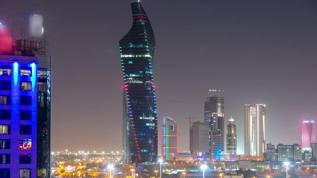 Skyline with Skyscrapers day to night timelapse in Kuwait City downtown illuminated at dusk. Kuwait City, Middle East