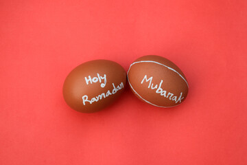 Obraz na płótnie Canvas Holy Ramadan Mubarak hand typography on the egg. Red isolated background.