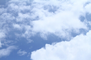 Beautiful blue sky and white clouds of various shapes with sunlight Nature background