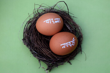 Bengali new year hand typography on the egg. Green isolated background. Bengali translated...