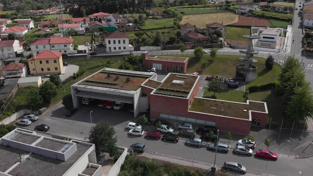 Santo Tirso, Portugal - May 1, 2021: DRONE AERIAL FOOTAGE - The Santo Tirso fire station (Bombeiros Voluntarios Santo Tirso). Car accident exercise of the volunteer fire department.