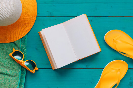 Reading on summer vacation holiday, book with blank mock up pages, flat lay top view