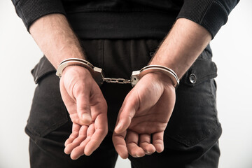 man hand handcuffs in back