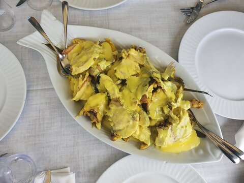 A typical dish from Ibiza calles 'bullit de peix'. It has fish, potatoes and mayonnaise sauce. Served in a fish dish, on a restaurant.