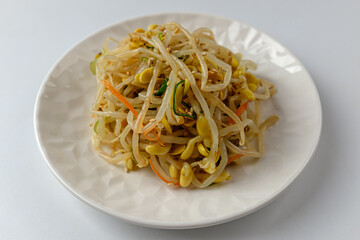 Tossed bean sprouts on a white background
