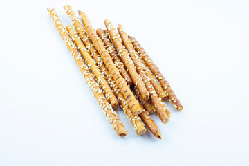 Crispy brown bakery sticks with sesame, crunchy salted dessert, isolated food, object, design element