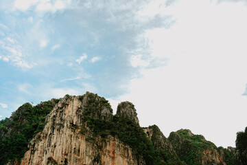 Green mountains under the blue sky. Close up of mountain. View from below.
