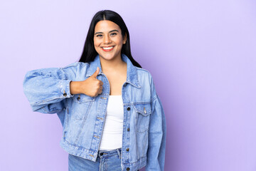 Young latin woman woman over isolated background giving a thumbs up gesture