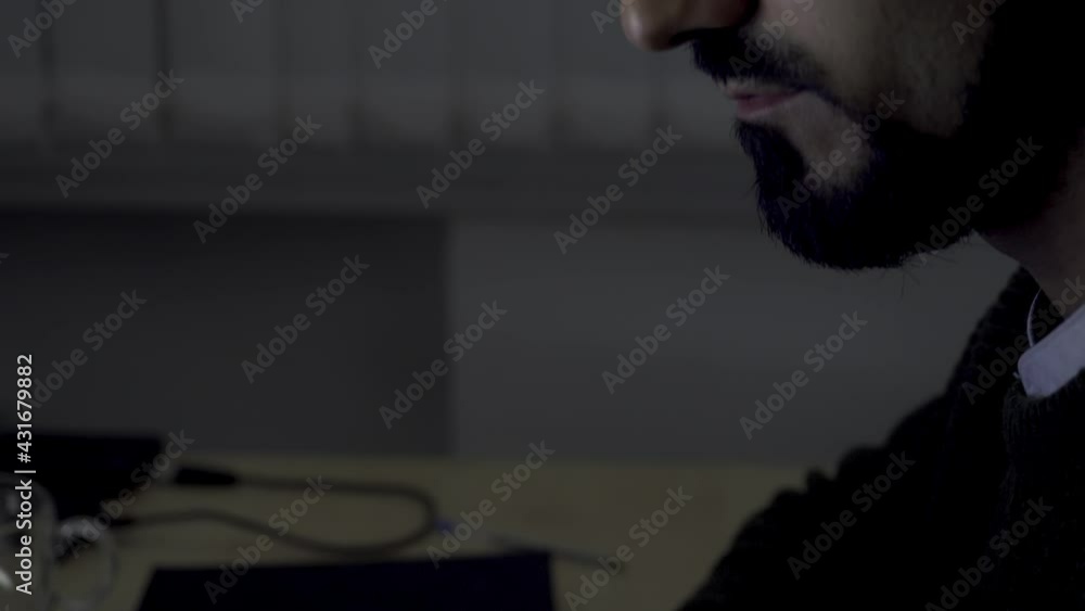 Poster close up side view of a businessman or programmer typing on laptop keyboard at a desk in the office.