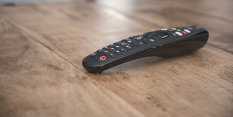 TV remote control on wooden table