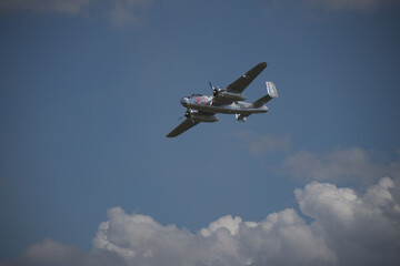 Historic airplane flying through the clouds
